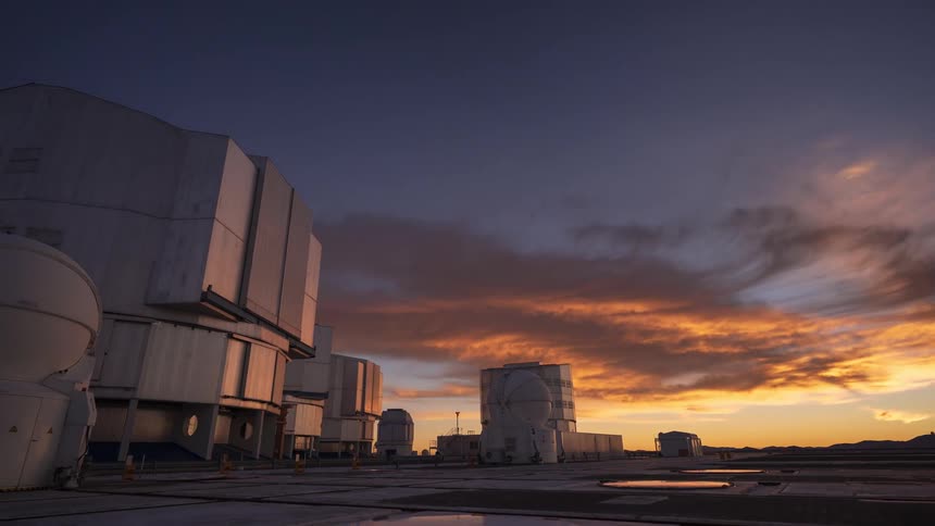 Watch the sky transition from starry night through a vibrant, colorful sunrise to clear blue day in this stunning timelapse over an astronomical observatory