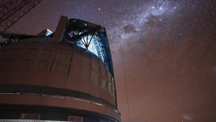 A stunning time-lapse captures the Milky Way and Magellanic Clouds moving across the night sky as a large observatory dome rotates below