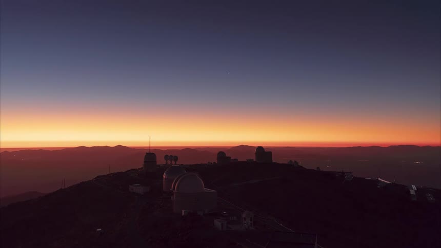 A stunning day-to-night time-lapse of the sun setting over the Cerro Tololo Inter-American Observatory, revealing a beautiful starry night sky