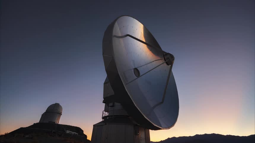 Epic timelapse transitions from a star-filled night sky with the Milky Way to a golden sunrise over a remote radio telescope observatory