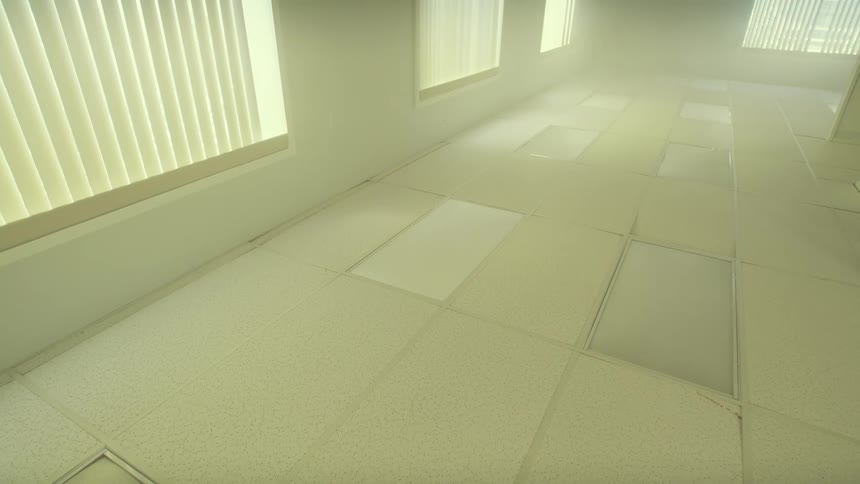 A slow, disorienting pull-out shot reveals a mysterious, hazy, and empty office room that is flipped completely upside down