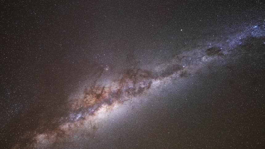 A stunning time-lapse of the Milky Way galaxy traveling across the night sky before fading into the light of dawn