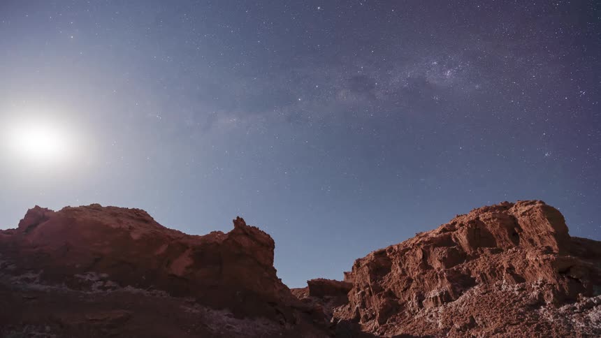 A stunning timelapse of the Milky Way moving across the night sky above a desert canyon as the moon rises to illuminate the landscape