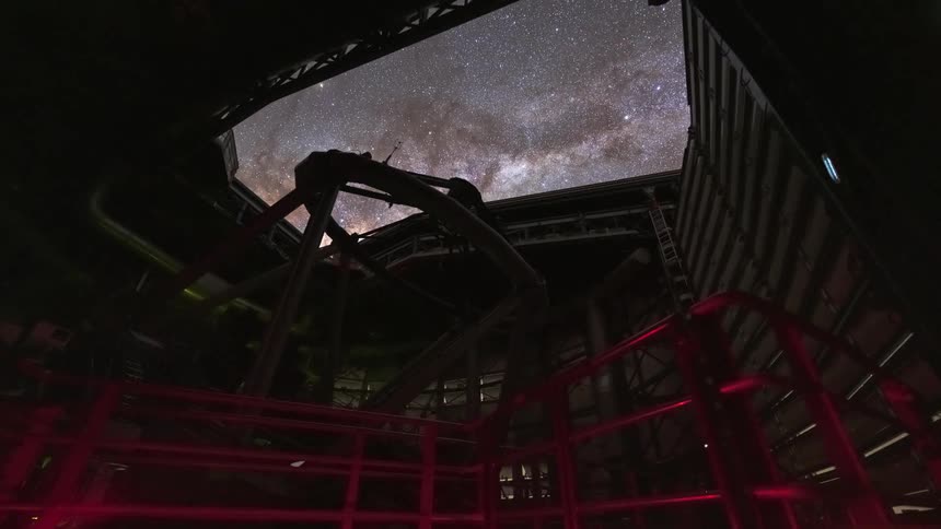 Time-lapse from inside a large observatory as the telescope moves and the roof opens to track the stunning starry night sky and the Milky Way