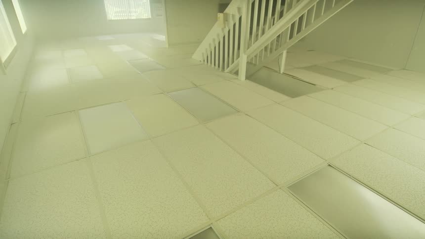 Smoke fills an empty training facility with a staircase during an emergency fire drill simulation
