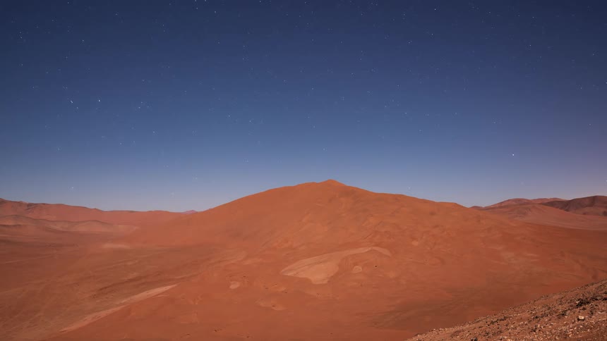 A stunning day-to-night-to-day time-lapse of giant sand dunes in the desert, transitioning from a vibrant sunset to a starry night sky and a foggy sunrise