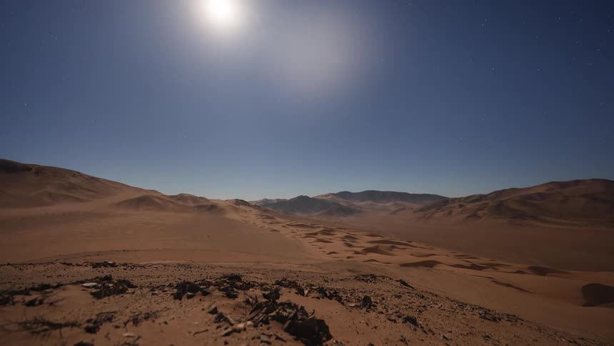 An epic day-to-night-to-day timelapse shows a desert sunset, a star-filled sky with a setting moon, and a valley filled with rolling fog before sunrise