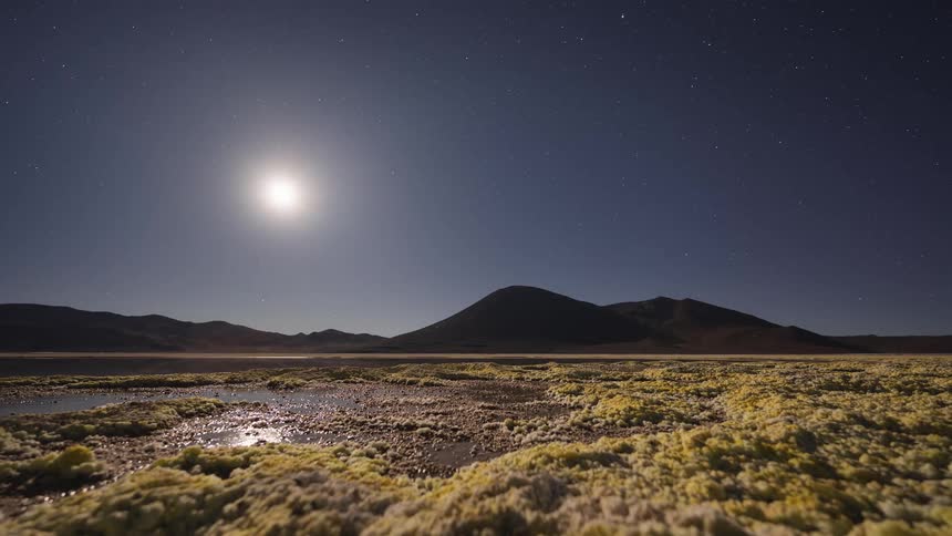 An epic day-to-night-to-day holy grail timelapse over a surreal volcanic lake captures the sunset, moonset, starry sky, and a brilliant sunrise