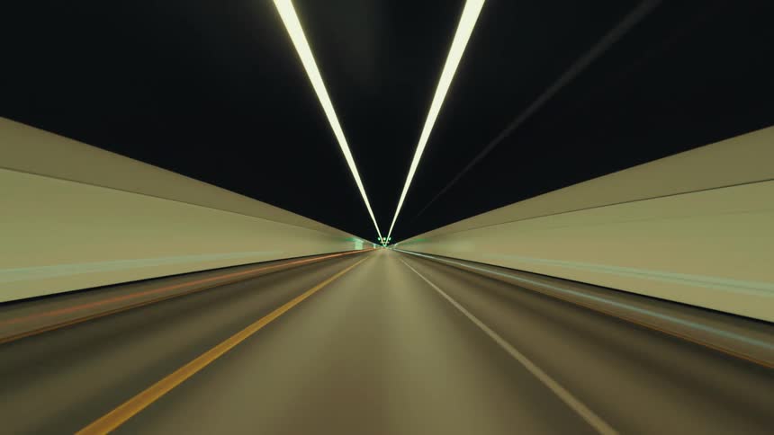 A seamless, hypnotic loop of a high-speed drive through a brightly lit underground highway tunnel from a driver's perspective