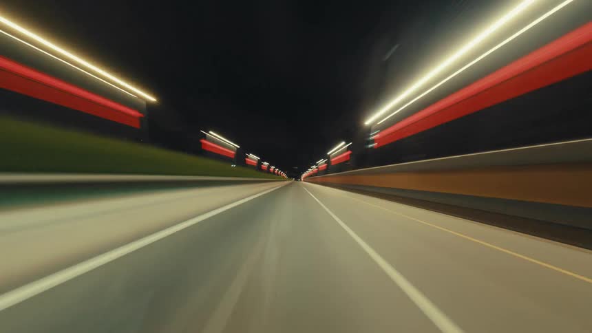 A dynamic hyperlapse from the driver's perspective captures the blur of city lights while speeding down a highway at night