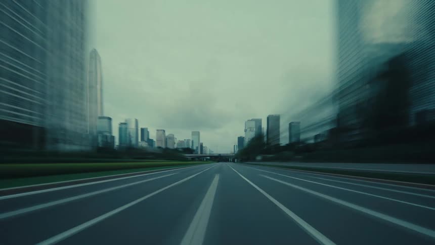 A moody time-lapse from a driver's perspective speeding through an empty modern city with motion-blurred skyscrapers