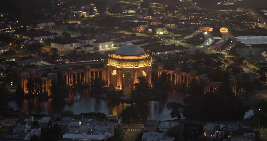 A stunning aerial view of the illuminated Palace of Fine Arts in San Francisco as the camera slowly pulls back at night