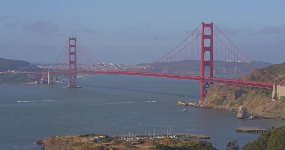 The iconic Golden Gate Bridge stands majestically over the San Francisco Bay on a bright, sunny day