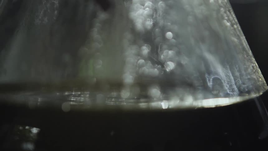 The coffee pot is slowly brewing coffee