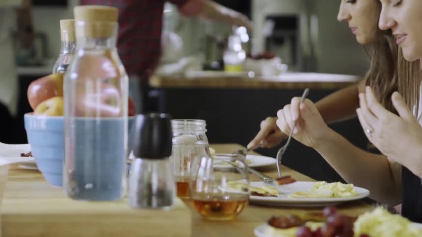 People eat breakfast at a table