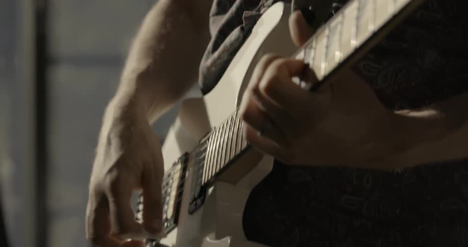 A man is playing an electric guitar