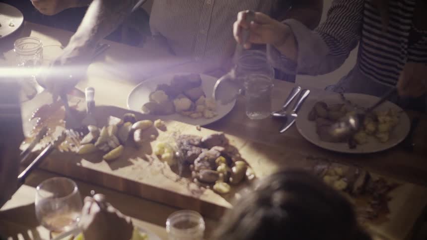 People eating a large family style meal