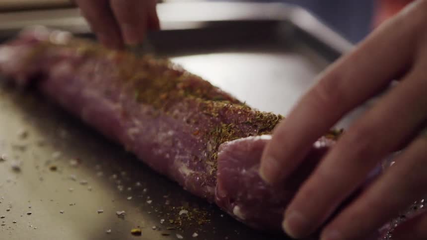 A piece of meat is seasoned