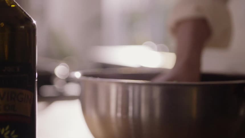 Woman mixing food in a bowl with her hand