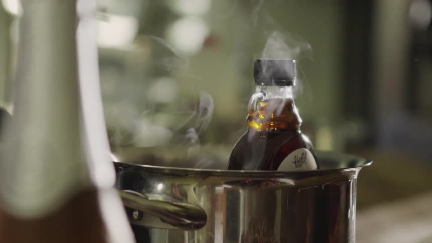 Steam rises from a pot in a kitchen