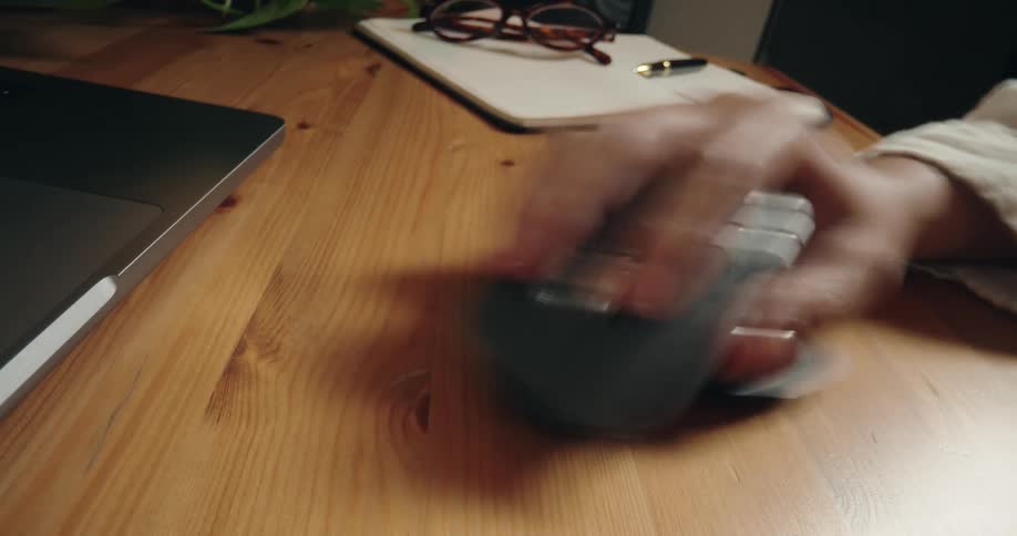 Time-lapse close-up of a hand rapidly clicking and scrolling with a wireless ergonomic mouse on a wooden desk