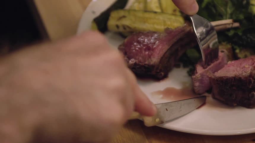 A person cuts a piece of meat