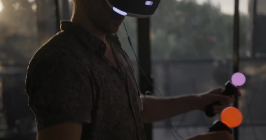 A man is playing a game with a vr headset