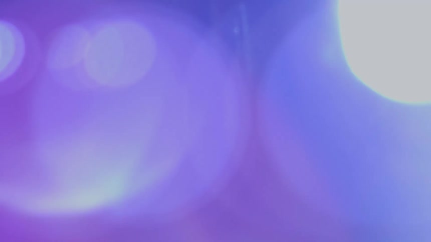 Dreamy blue and purple bokeh lights create a soft, out-of-focus atmospheric background