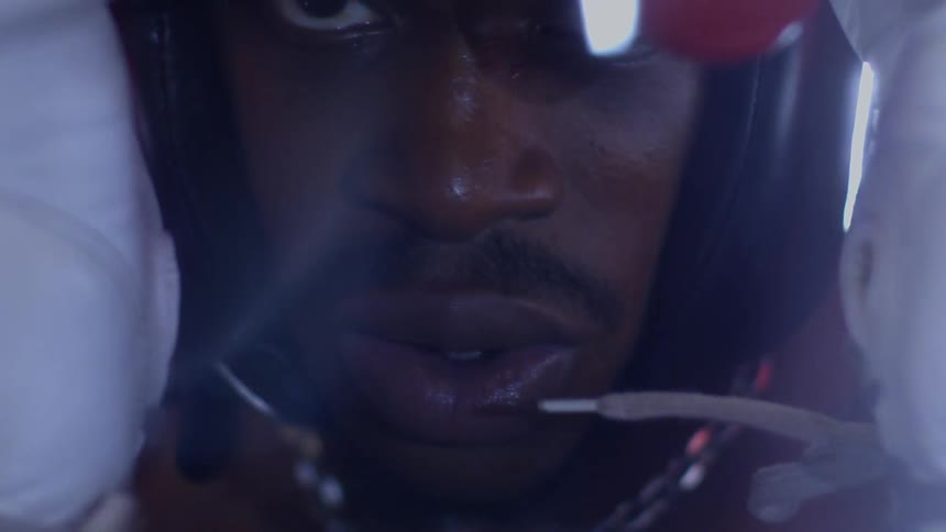 An intense close-up shot of a determined boxer focusing with his red gloves up
