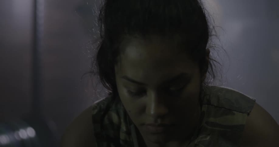 Depressed looking woman in a dimly lit room