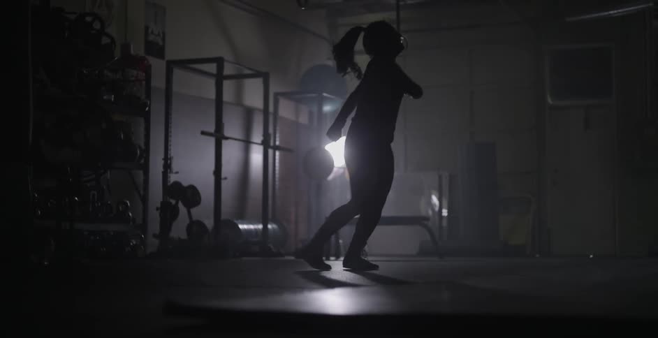 A woman dances around a fitness room