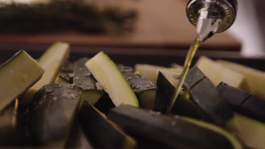 Oil is poured on food in a pan