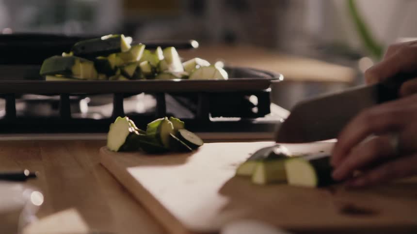 A person chops vegetables