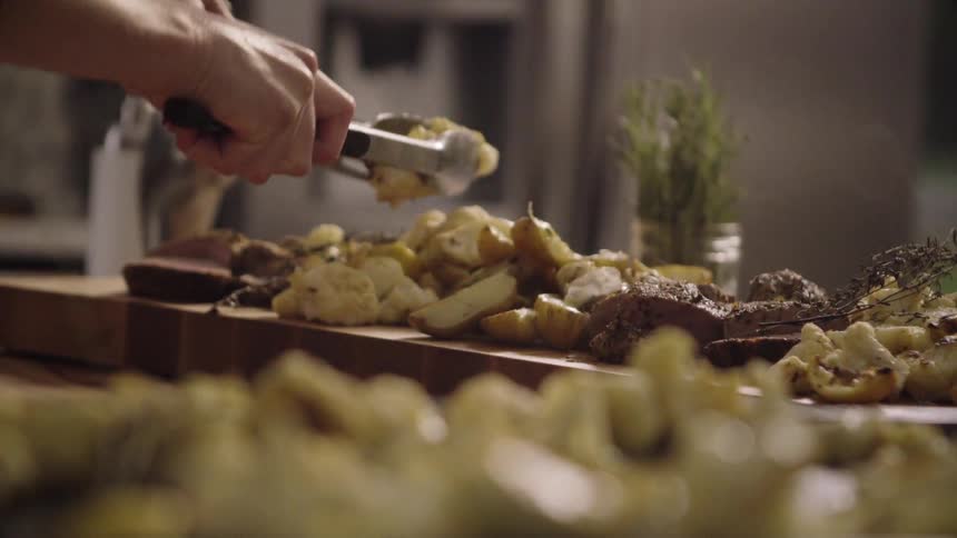 Food is picked up with tongs and served