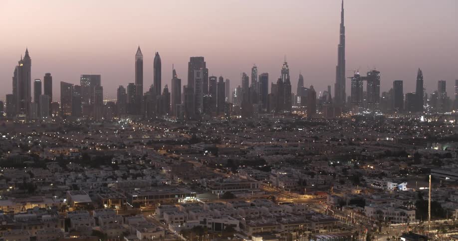 City buildings shine at sunset