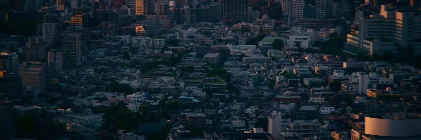 A tranquil aerial view of a dense metropolitan cityscape during a beautiful golden hour sunset