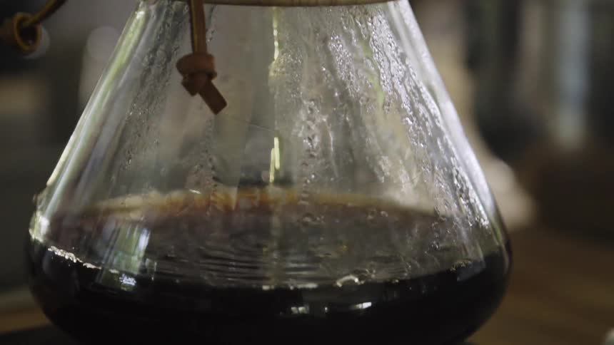Coffee drips through a filter into a carafe