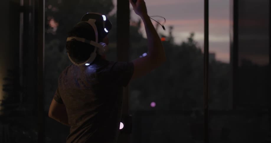 A man is using a vr headset and controllers