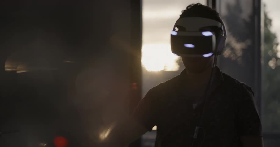 A man looks around while wearing a virtual reality headset