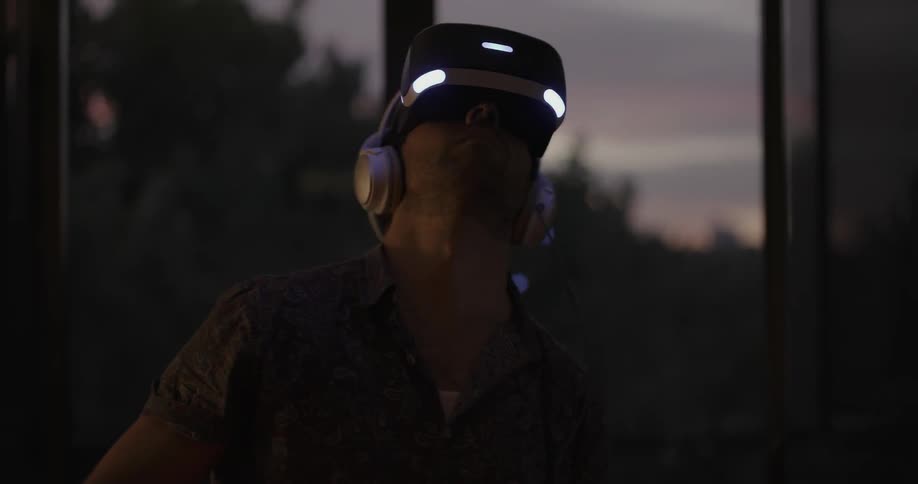 A man is looking around swinging controllers