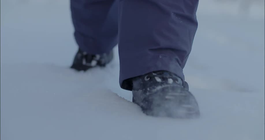 Person shuffles through the snow