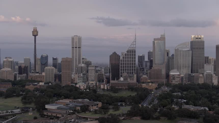 The city ahead has many towers and cars traveling towards it