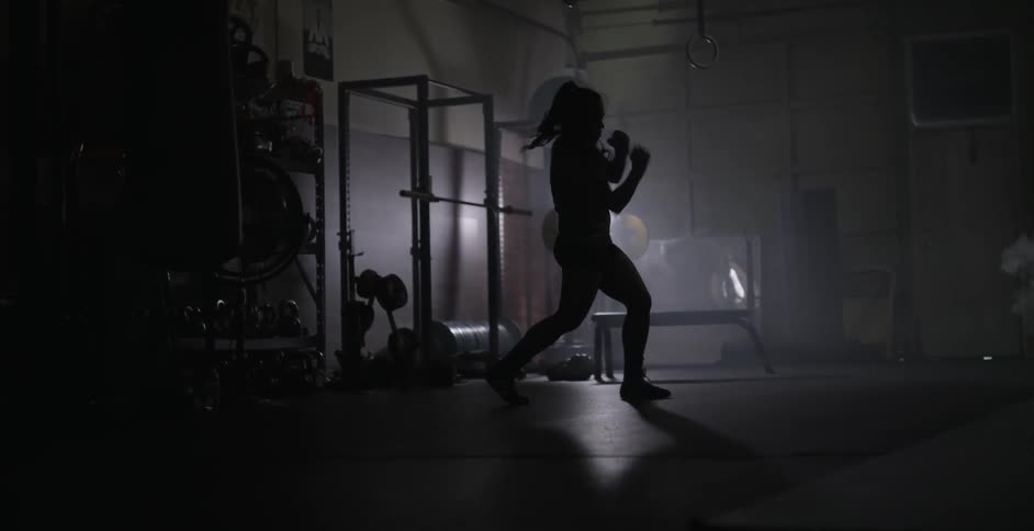 A woman dances around warming up in this gym