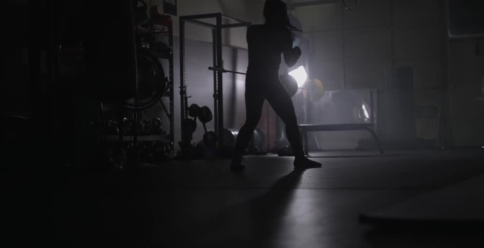 A woman punches the air in a fitness studio