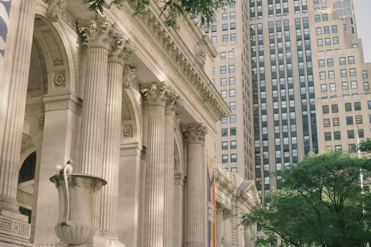 A cinematic dolly shot reveals the grand classical architecture of the New York Public Library in Manhattan