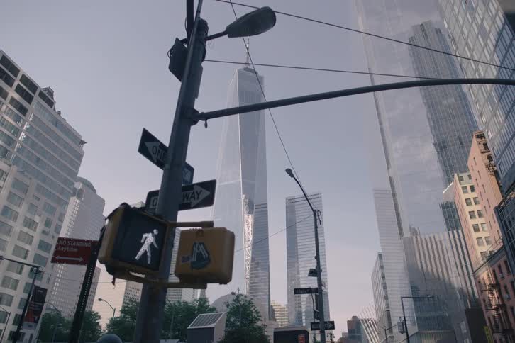 A slow-motion push-in shot from a low angle on a New York City street reveals the majestic One World Trade Center