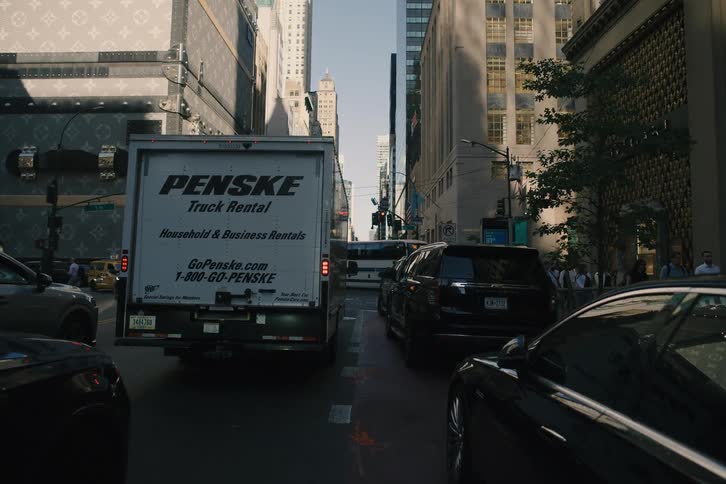 Slowly driving through dense daytime traffic on a famous luxury shopping street in New York City