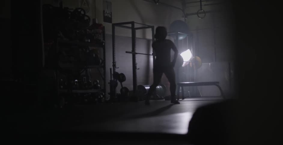 A woman dances around in a gym