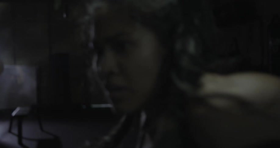 A female fighter is punching a bag in a gym