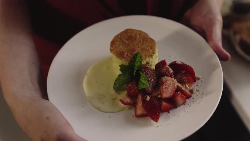 Close up of a biscuit and strawberries on a plate